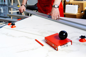 The process of cutting a marble slab using special tools. Work with stone in production