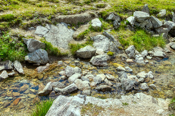Fototapeta na wymiar mountain waterflow with stones surrounded. austria, carinthia