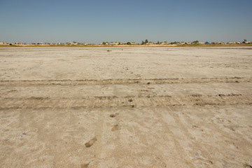 Close-up of sand on the beach of the salty pink lake Bursol (Altai Territory).