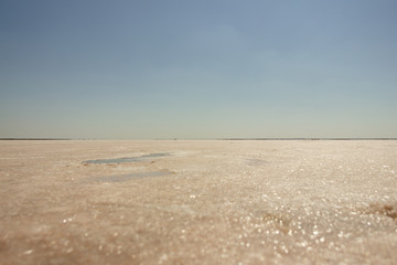 Fototapeta na wymiar Close-up of sand on the beach of the salty pink lake Bursol (Altai Territory).