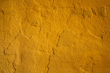 Yellow painted stucco wall texture