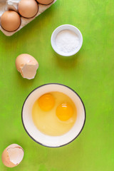  Cracked egg with Yolk egg in ceramic bowl and raw eggs