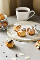 Homemade eclairs with chocolate cream for breakfast