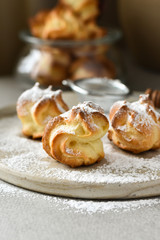 Homemade eclairs with chocolate cream for breakfast