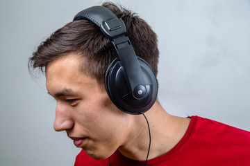 portrait of a guy with headphones listening to music