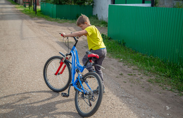 Boy riding a bike in summer