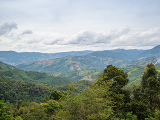 Scenic view of mountains against cloud sky