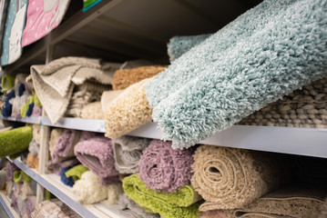 Bath mat assortment on a store counter close up background.