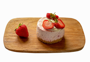 An individual sized strawberry cheese cake