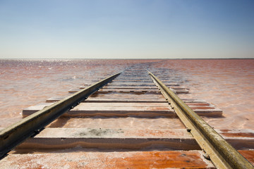 Close-up of the railway on the beach of the salty pink lake Bursol (Altai Territory).