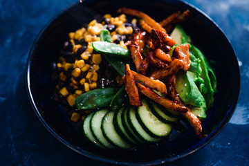 plant-based food, vegan poke bowl with beans corn avocado cucumber and air fried marinated tofu
