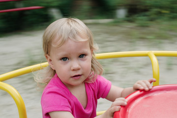 Fototapeta na wymiar baby girl playing in the children playground