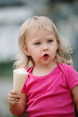 baby girl eat ice scream in the city, happy and smile