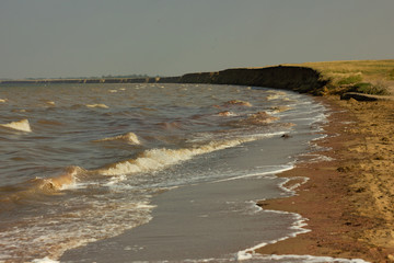 Close-up of sand on the beach and water of the Yarovoe salt lake (Altai Territory).