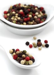 Five Peppercorns, peper nigrum against White Background