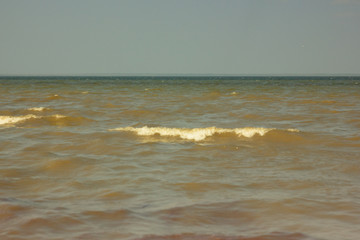 Close-up of sand on the beach and water of the Yarovoe salt lake (Altai Territory).