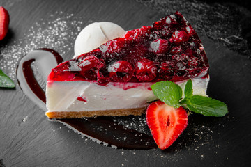 Strawberry raspberry cheesecake with a scoop of ice cream