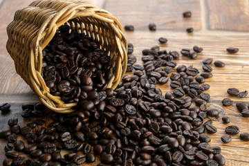 Coffee beans spilled out from a wicker basket