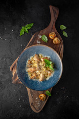 Gourmet delicious tagliatelle pasta cooked with grilled chicken pieces, fried mushrooms and parmesan cheese. Balanced nutritious dish. Still life for restaurant poster