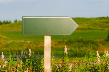 Wooden pole with tourist sign in the form of arrow, summer nature. Space for text. Pointer mockup,...