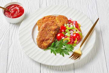 breaded lamb chops served on a plate