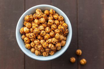 Roasted Chickpea in a bowl on wooden background. Turkish known as leblebi