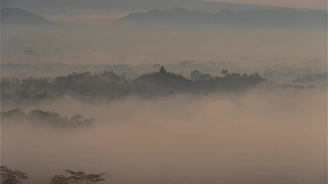 Silhouette of Borobudur Temple, Mount Merbabu and Mount Merapi Volcano from Punthuk Setumbu Hill During Sunrise, Clouds Fog Mist Time Lapse - Yogyakarta - Magelang, Central Java, Indonesia, Indonesian