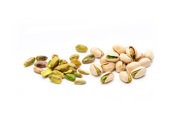 Group of pistachios with white background some of them peeled