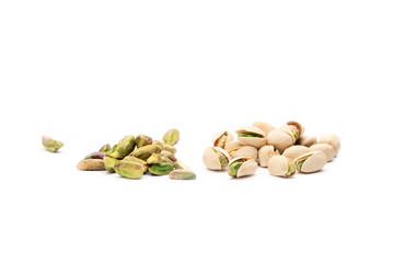 Group of pistachios with white background some of them peeled