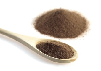Four Spices in a Wooden spoon, against White Background