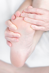 Fototapeta na wymiar Bare feet feel pain with foot massage