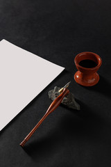 Calligraphy master work table with paper and pen