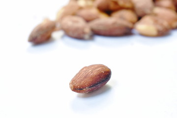 Obraz premium baked almond seed batch on white background