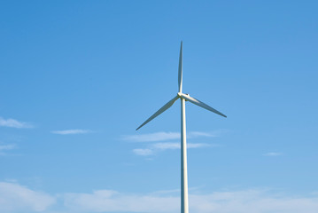 Wind turbine against blue sky. Wind power energy concept
