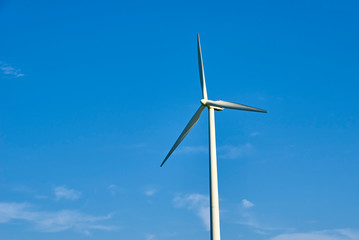 Wind turbine against blue sky. Wind power energy concept