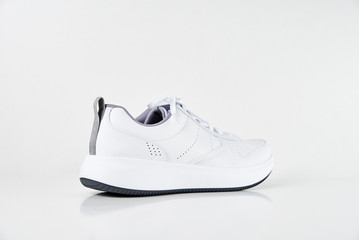 White male sneaker on white background isolated. Fashion stylish sport shoes, close up