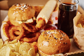 Unhealthy and junk food. Different types of fast food on the table, closeup