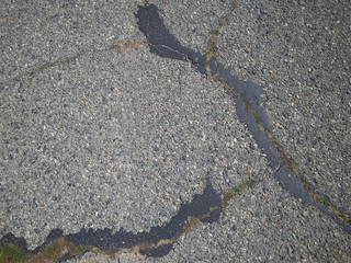 Asphalt road texture. The asphalt is covered with cracks