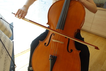 チェロを弾く若い女性　柔らかい光が射す部屋で woman playing the  cello © kesuku