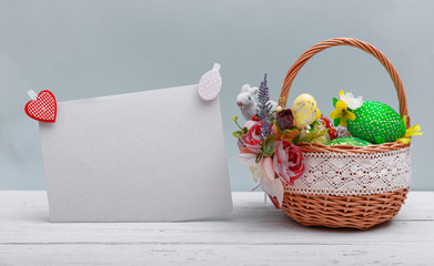 Easter eggs basket in a green grass garden. With copy space for your greetings