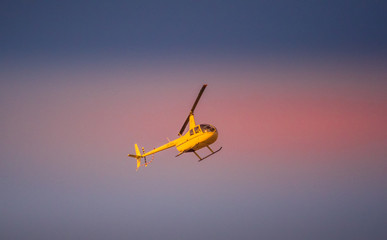 Helicopter sortie flying high on a rescue mission with strong propellers