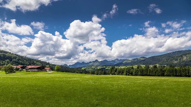 4k timelapse of a dramatic cloudscape with fast moving clouds in Reit im Winkl in the bavarian alps during a windy day in summer.