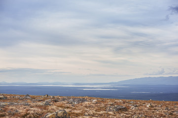 Scenic view of beautiful landscape with tundra hills and clouds