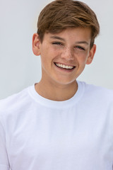 Boy teenager teen male child smiling happy and wearing a white t-shirt