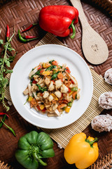 Crab meat fried bell pepper on the wooden background.