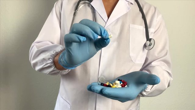 pharmacist, doctor in uniform holds pills, pills, new medicine, dietary supplement, concept of medicine, treatment of coronavirus, COVID-19