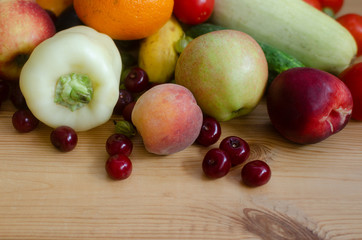 A mix of vegetables and fruits on the wooden table