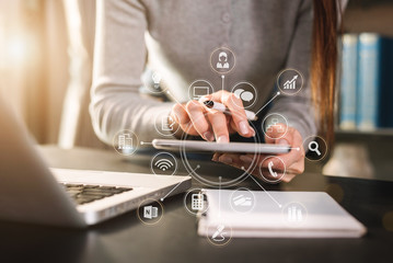 Send a message to a colleague, a businessman, confident in matching a tablet and sitting in office.