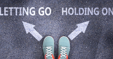 Letting go and holding on as different choices in life - pictured as words Letting go, holding on on a road to symbolize making decision and picking either one as an option, 3d illustration