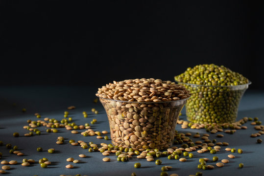 masoor dal in glass pot with blurry mung bean image, black background, photography